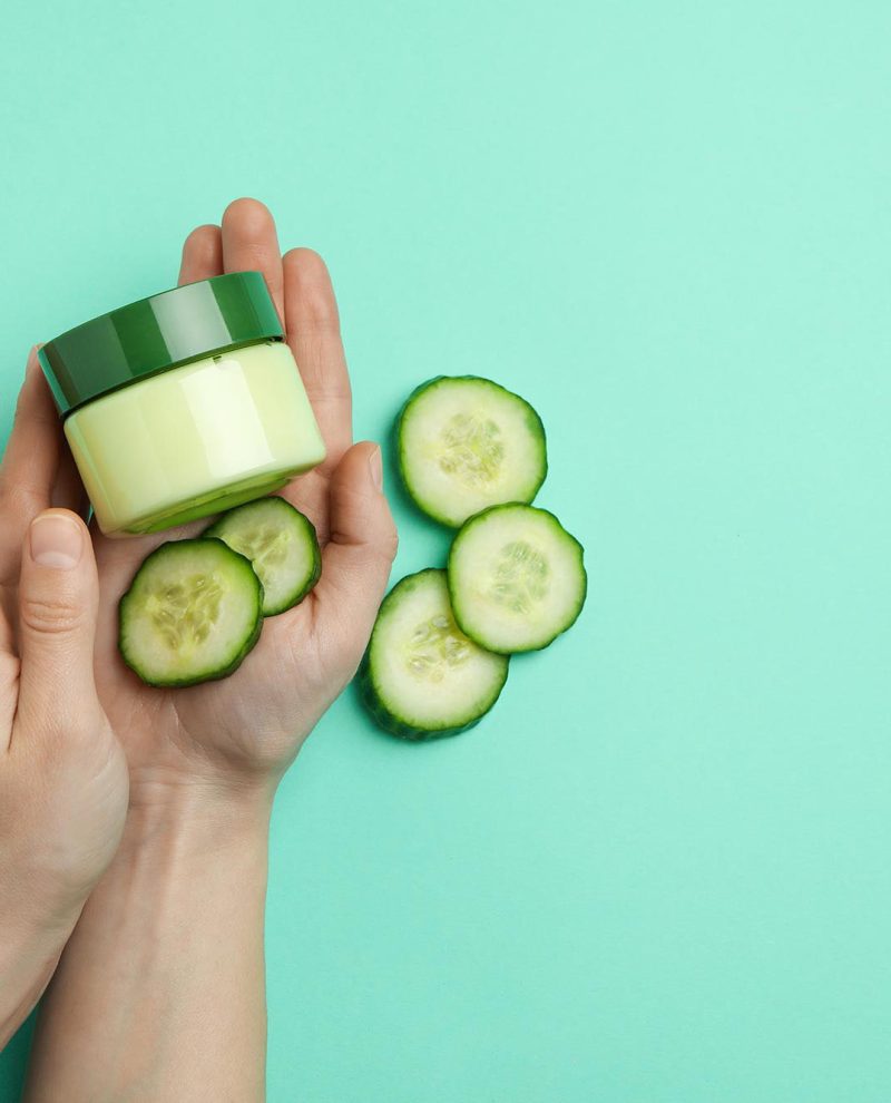 female-hands-hold-jar-with-cosmetics-on-mint-backg3-3APU6WW.jpg